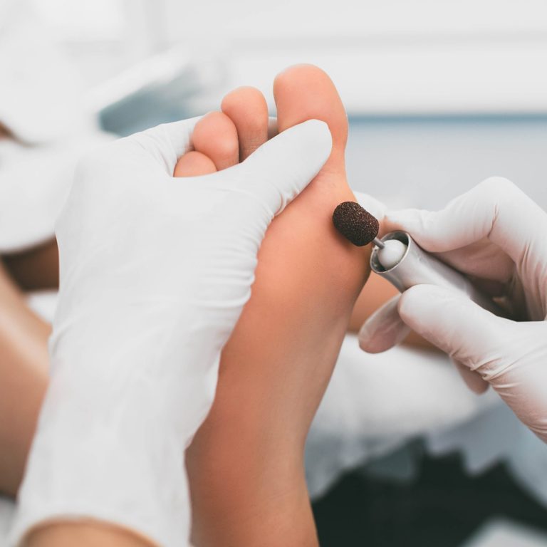 female legs close-up during a hardware manicure